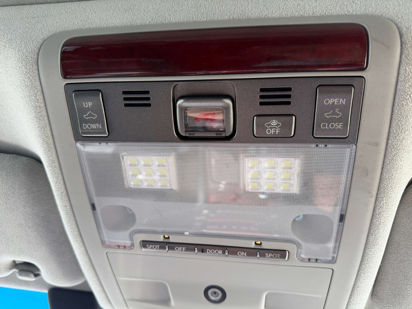 Interior ceiling control panel of a 2007 Lexus LS600hL AWD V8 5.0L Hybrid Luxury Sedan with LED lights.