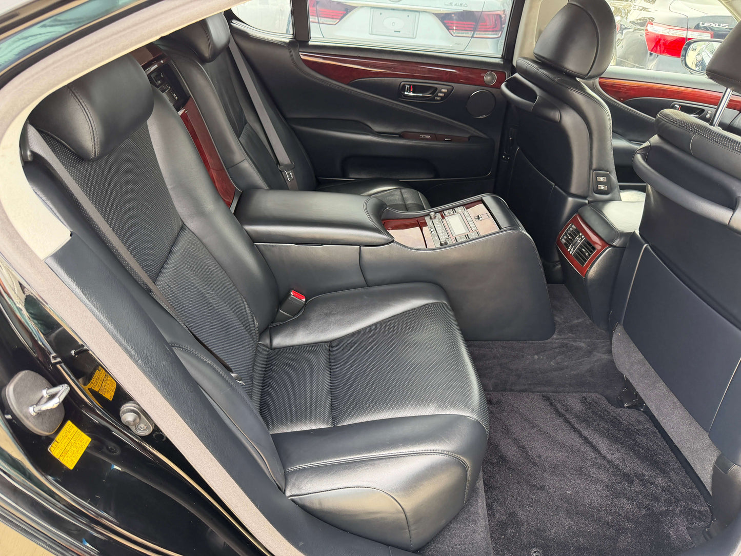 Interior view of 2007 Lexus LS600hL AWD V8 5.0L Hybrid luxury sedan showcasing rear leather seats.