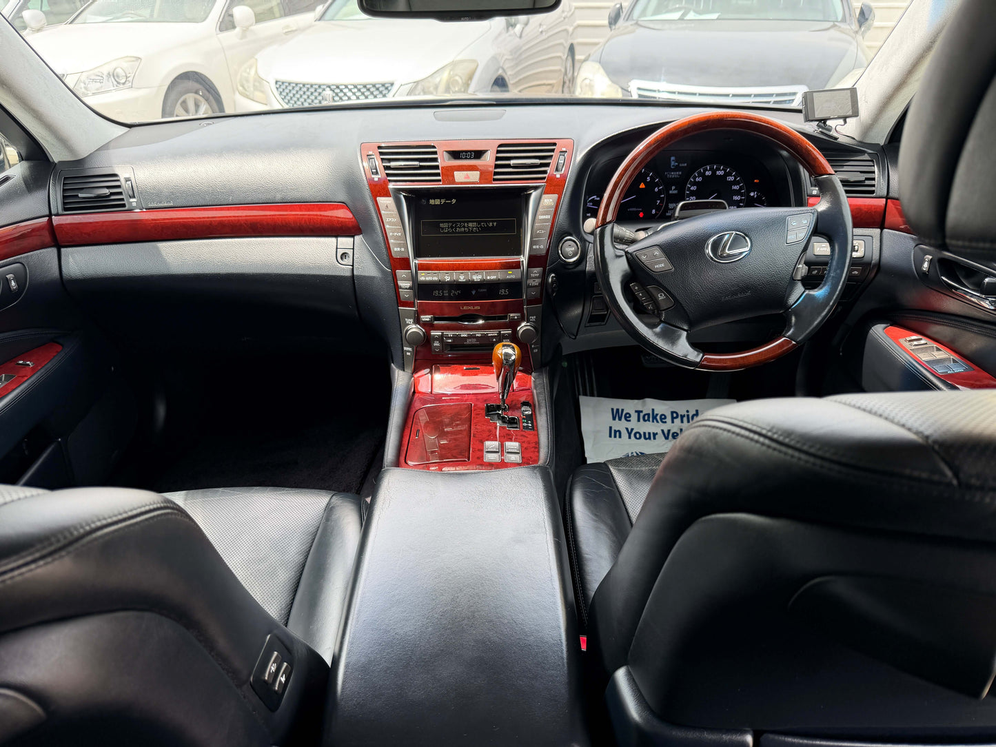 Interior view of a 2007 Lexus LS600hL AWD V8 5.0L Hybrid luxury sedan showcasing leather seats and dashboard.
