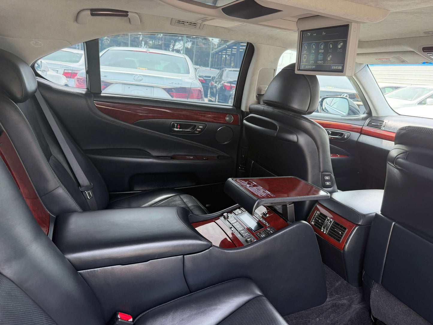 Interior of 2007 Lexus LS600hL AWD V8 5.0L Hybrid luxury sedan showing rear seats and entertainment system.