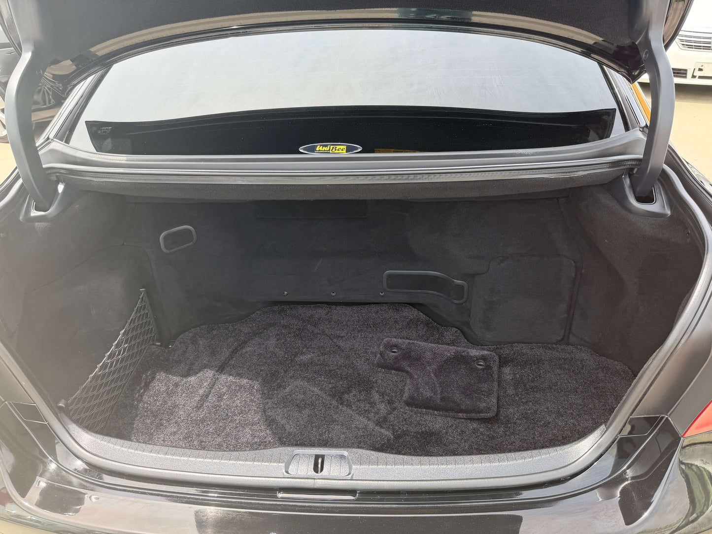 2007 Lexus LS600hL AWD V8 5.0L Hybrid trunk space interior view with carpet and storage net.