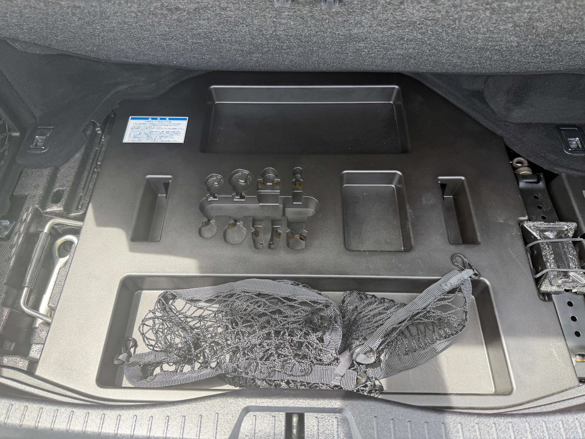 Storage compartment and accessories in the trunk of a 2007 Lexus LS600hL AWD V8 5.0L Hybrid Luxury Sedan.