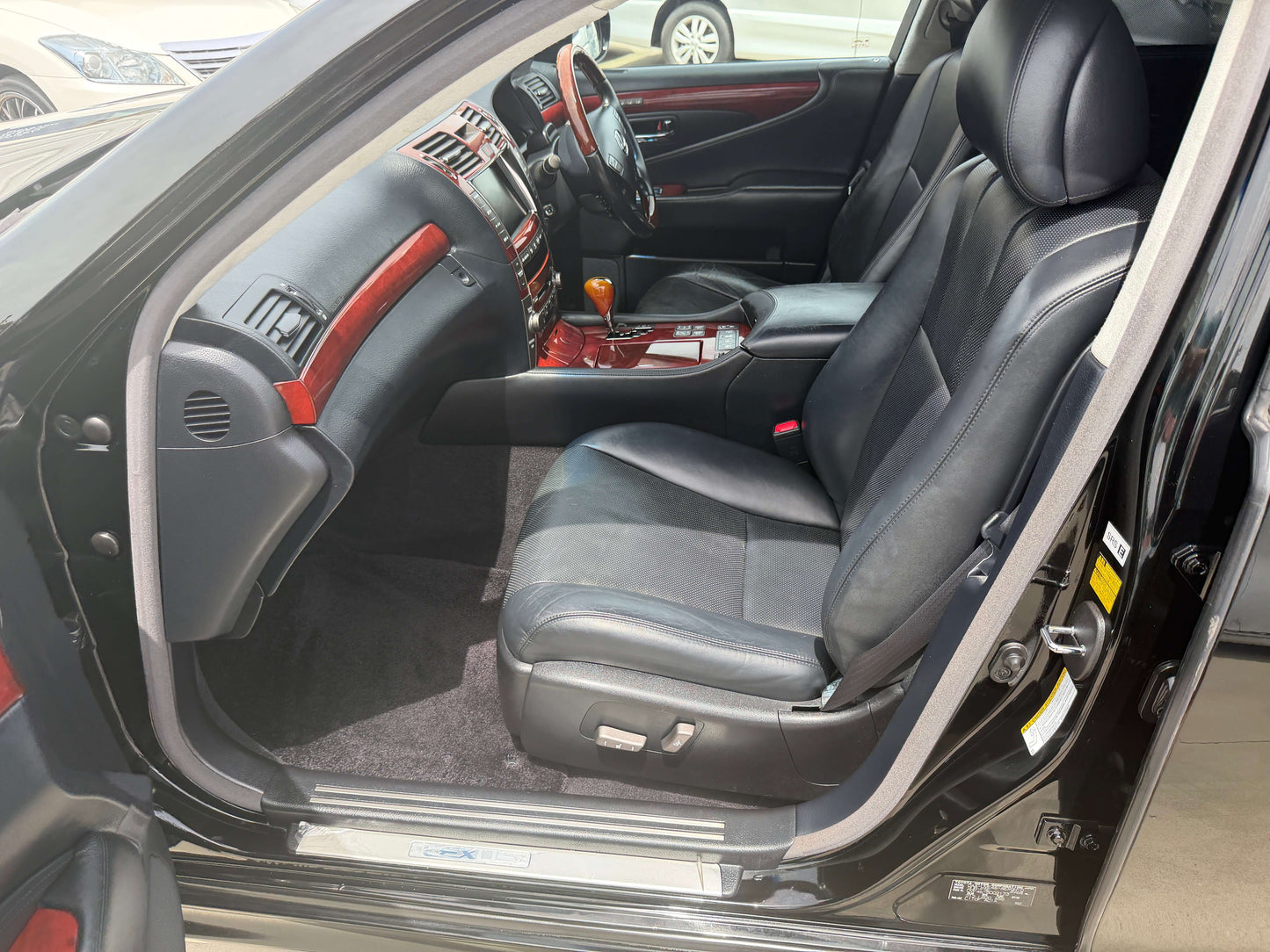 Interior view of 2007 Lexus LS600hL AWD V8 5.0L Hybrid Luxury Sedan showing leather seats and dashboard layout.