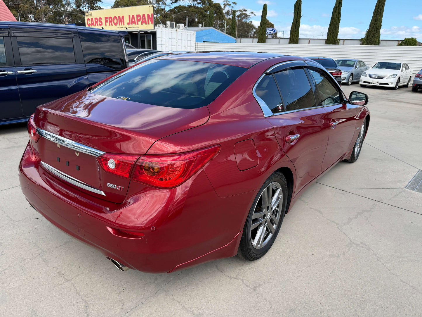 2015 Nissan Skyline V6 3.5L Hybrid rear view in deep red with elegant design and sporty features