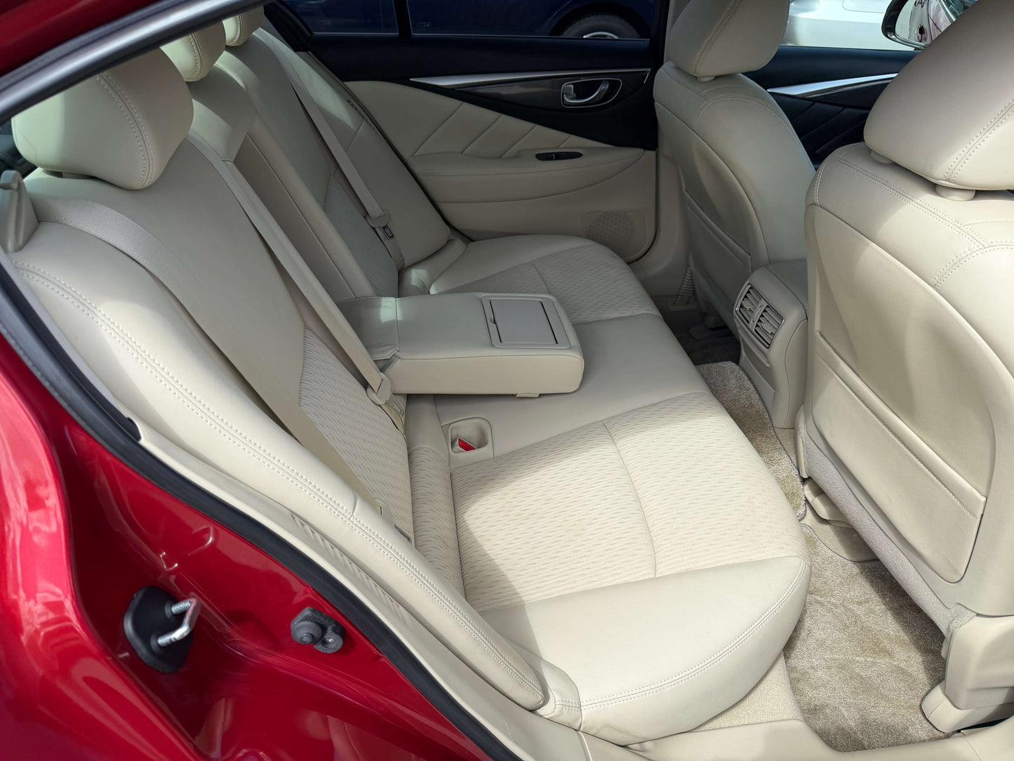 Interior view of the 2015 Nissan Skyline V6 3.5L Hybrid featuring beige leather seats.
