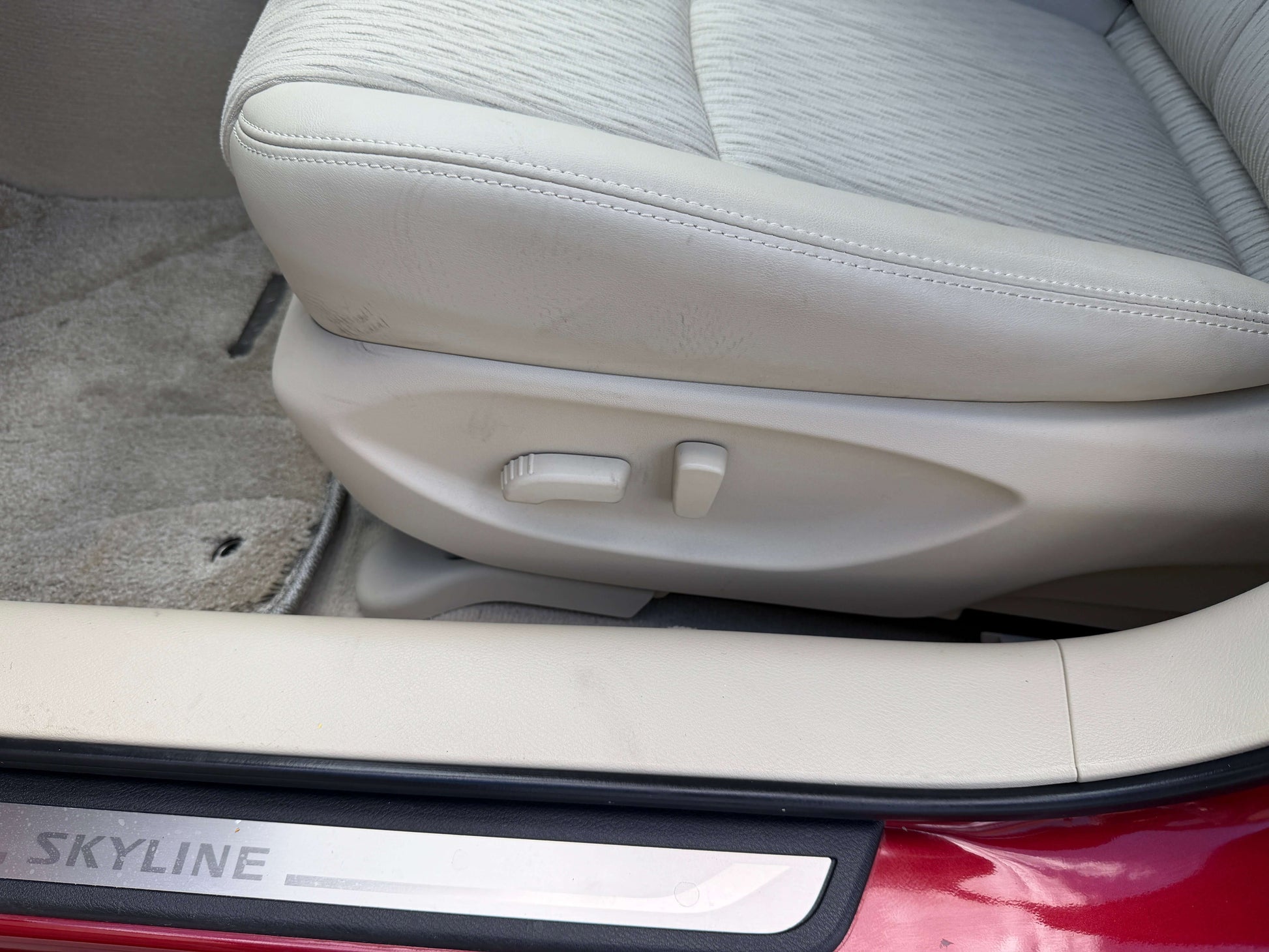 2015 Nissan Skyline V6 3.5L Hybrid interior seat adjustment controls with beige upholstery.