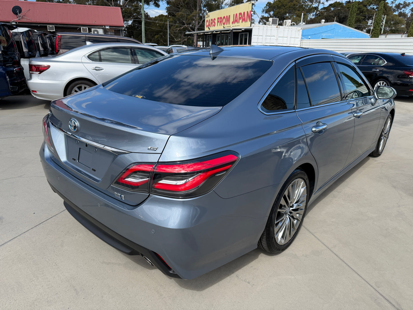 2019 Toyota Crown 2.5L Hybrid G Executive Edition Luxury Sedan rear view in blue with premium design features.
