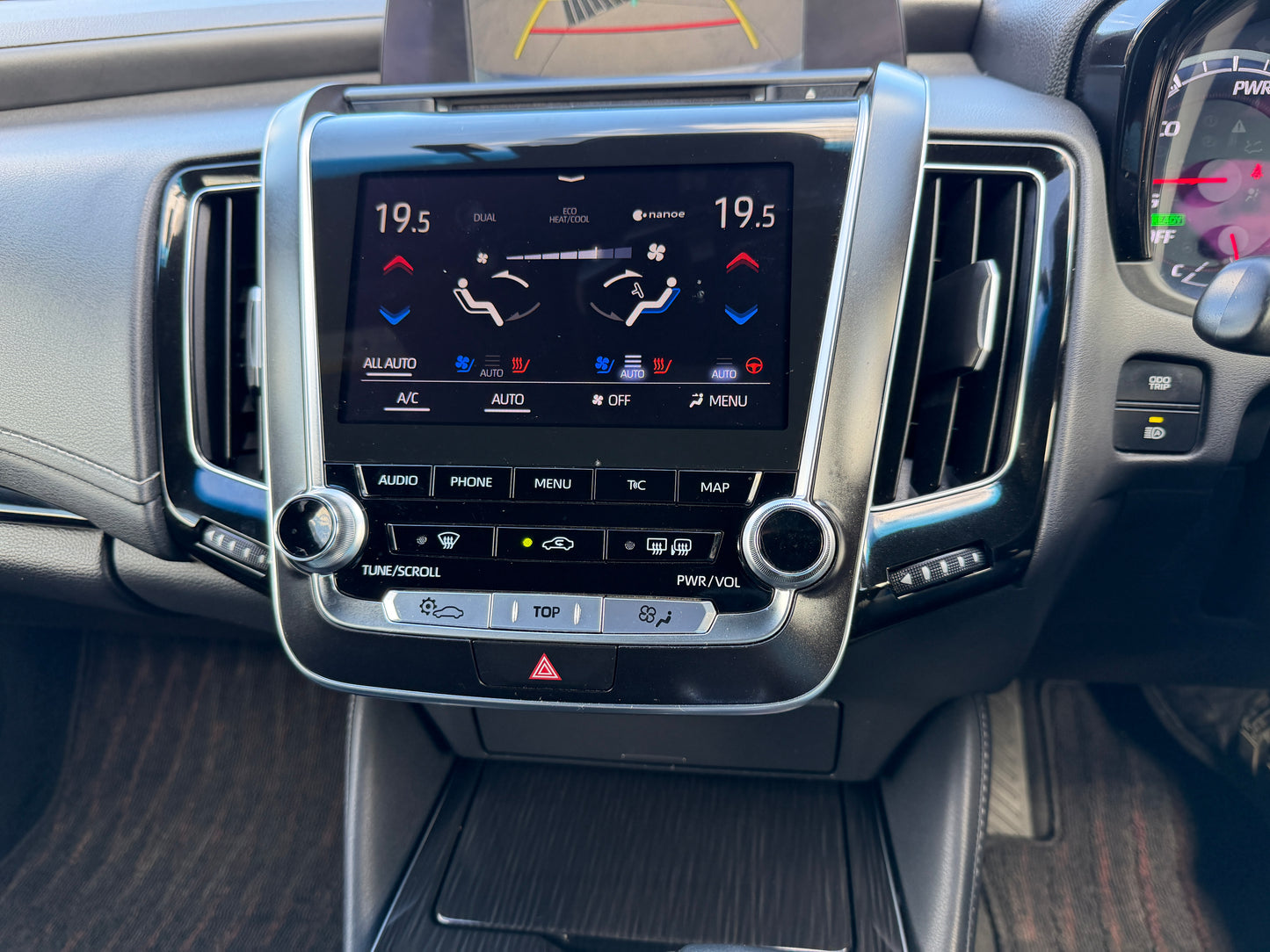 Interior dashboard of a 2019 Toyota Crown 2.5L Hybrid luxury sedan with climate control display and infotainment system.