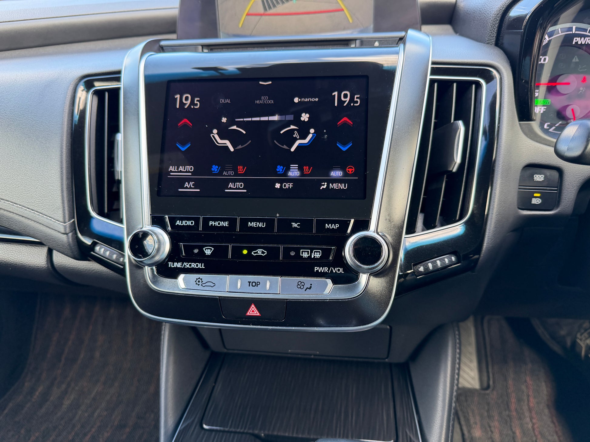 Interior dashboard of a 2019 Toyota Crown 2.5L Hybrid luxury sedan with climate control display and infotainment system.