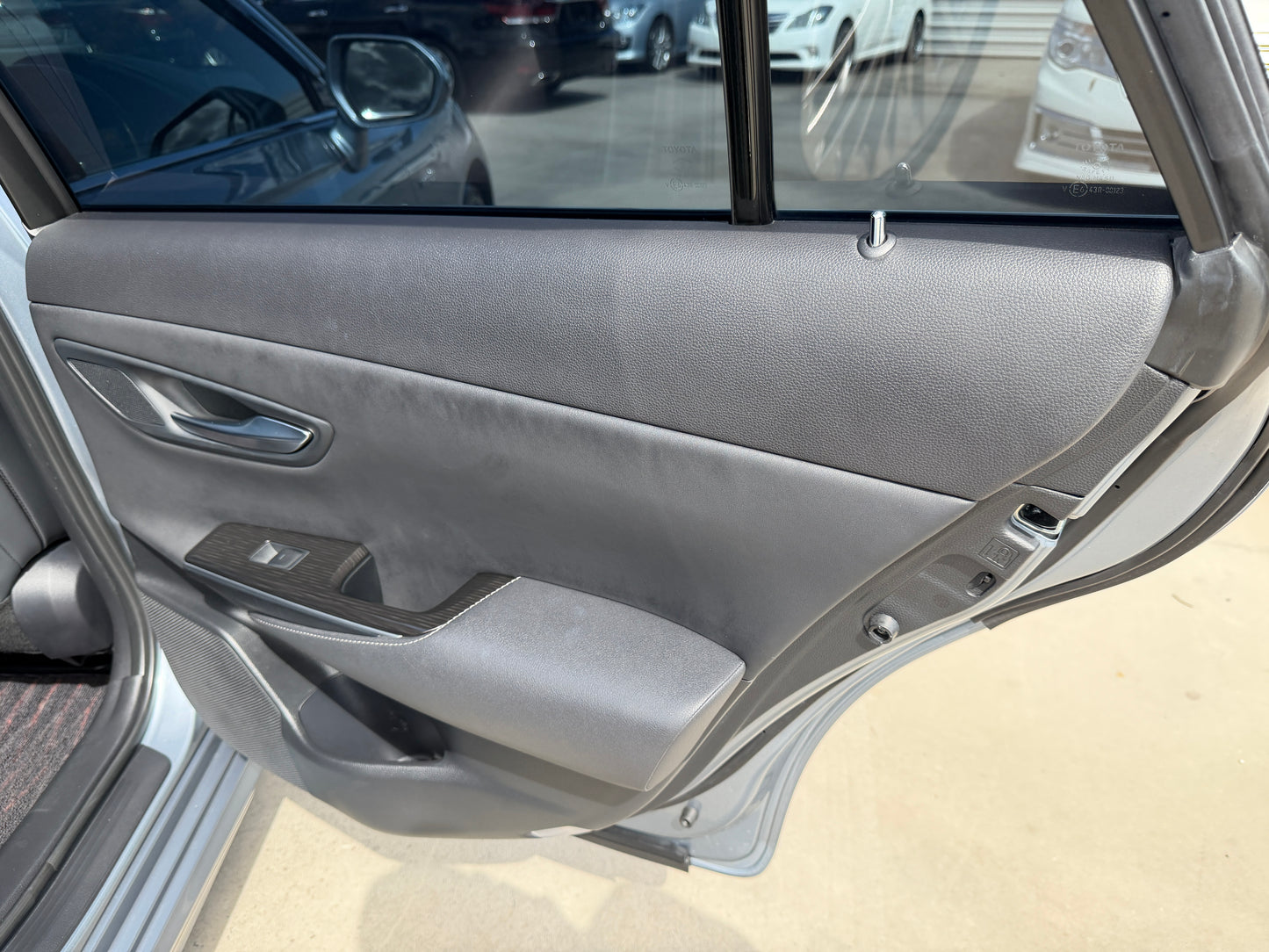 Interior view of the 2019 Toyota Crown 2.5L Hybrid G Executive Edition luxury sedan door panel.