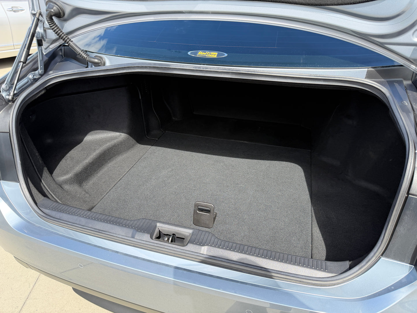 Interior view of the trunk space in a 2019 Toyota Crown 2.5L Hybrid G Executive Edition luxury sedan.