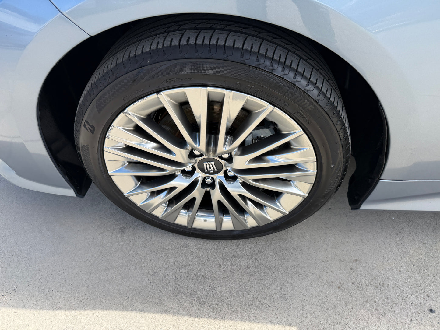 Close-up view of the alloy wheel and tire of a 2019 Toyota Crown 2.5L Hybrid G Executive Edition Luxury Sedan.