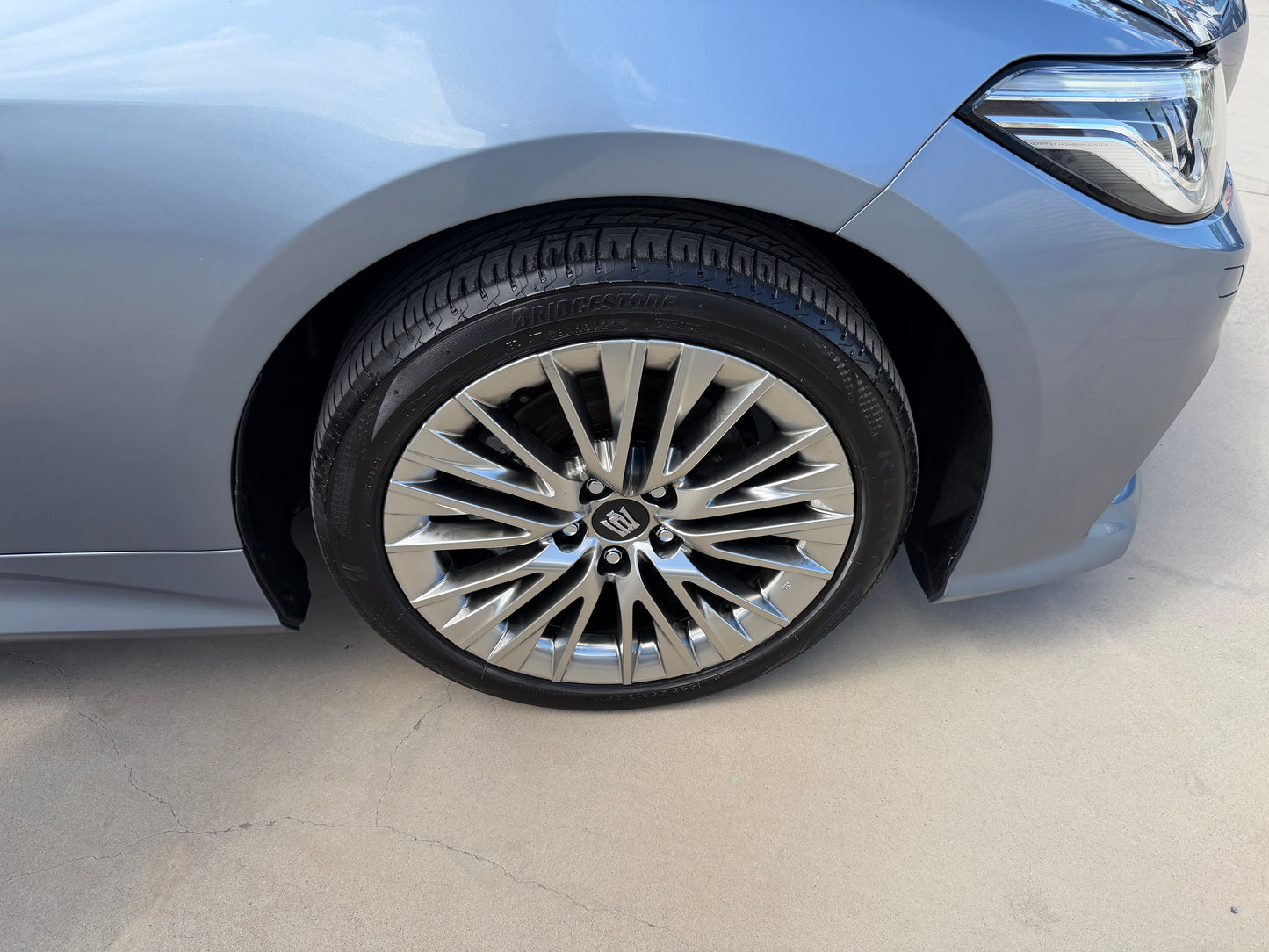 Close-up of the alloy wheel and tire of a 2019 Toyota Crown 2.5L Hybrid, showcasing its premium design and craftsmanship.