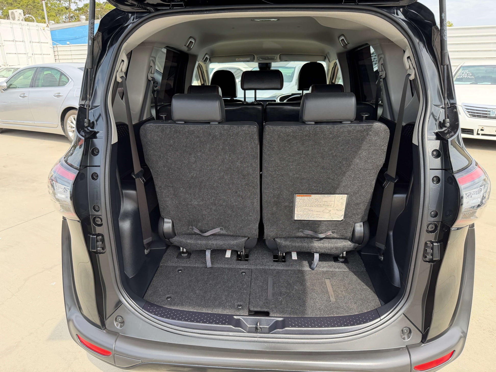 Interior view of 2018 Toyota Sienta 1.5L Hybrid G Cuero Package showing spacious rear seating area and cargo space.