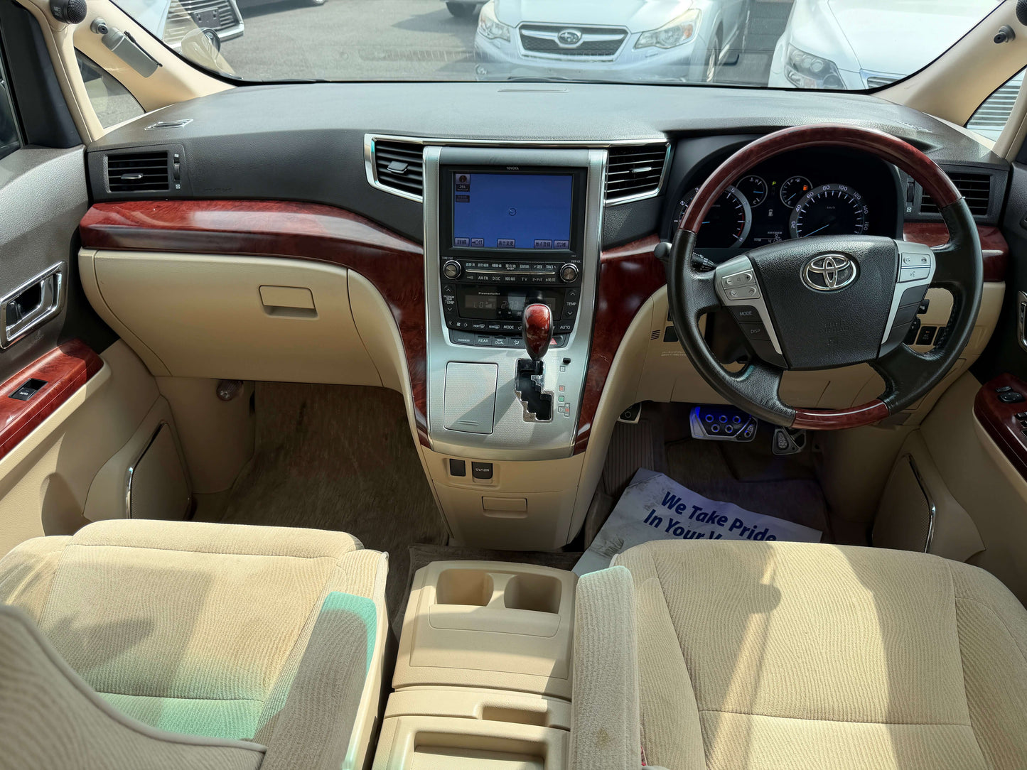 Interior view of the 2010 Toyota Vellfire 2.4L V Edition showing dashboard and seating.