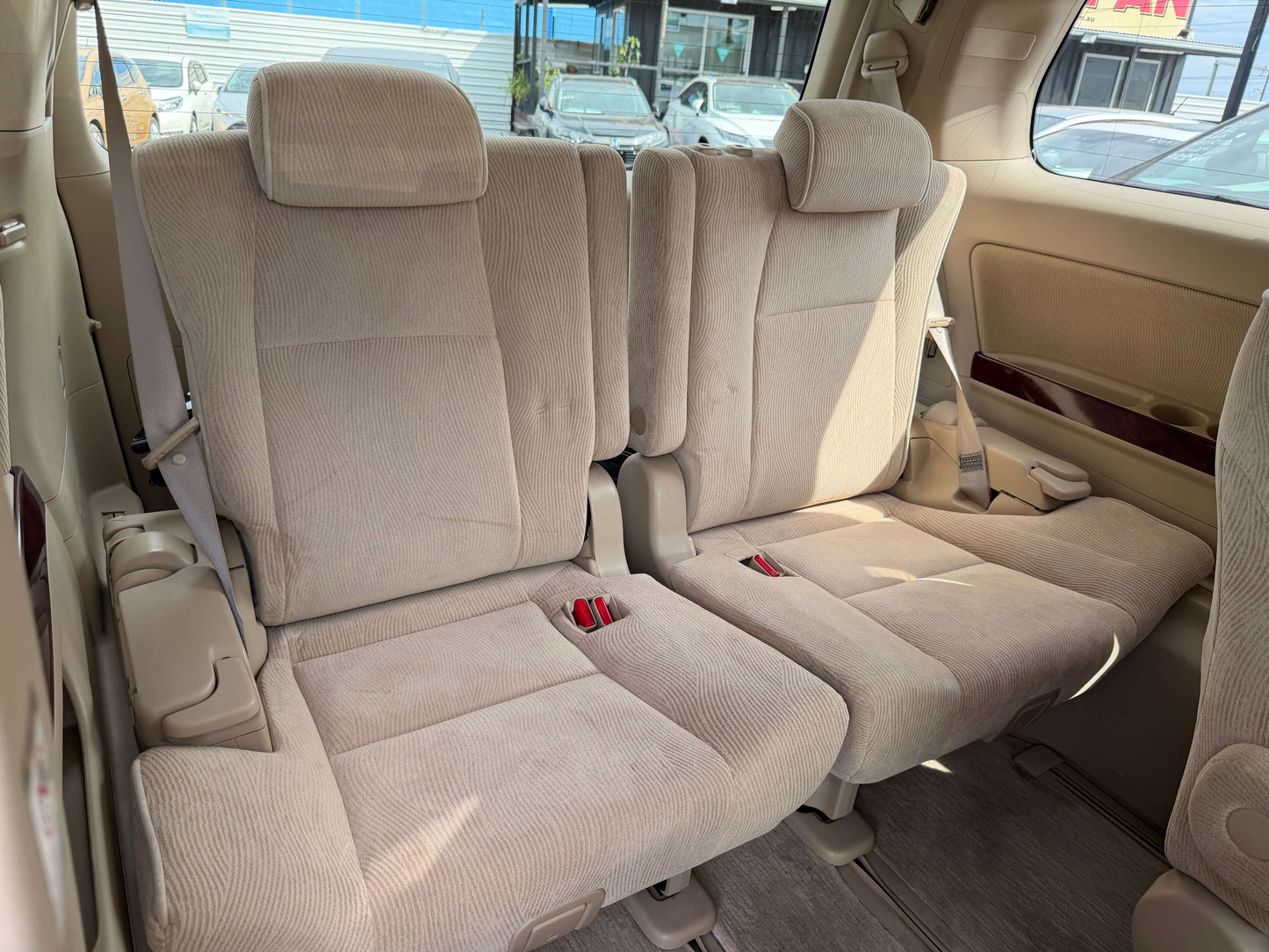 Interior seating of a 2010 Toyota Vellfire 2.4L, featuring beige upholstery and 7-seat configuration.