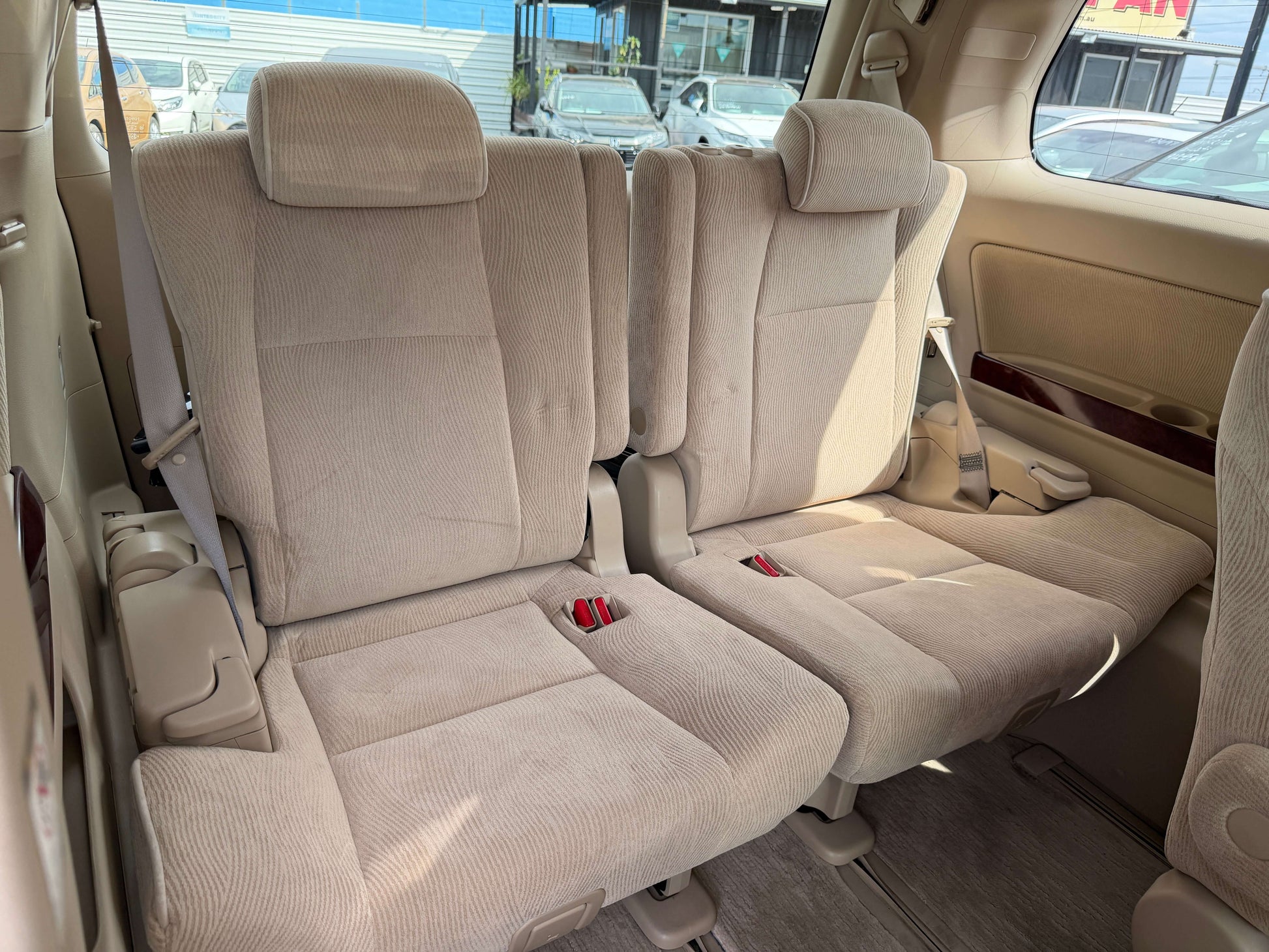 Interior seating of a 2010 Toyota Vellfire 2.4L, featuring beige upholstery and 7-seat configuration.