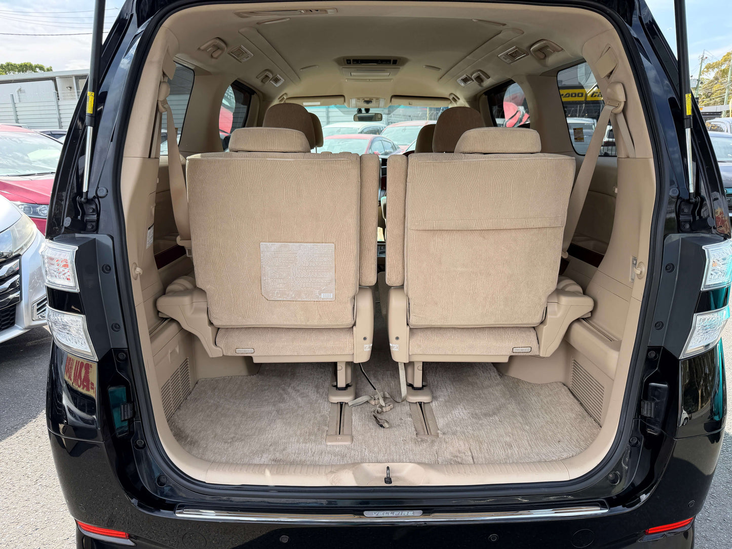 Interior view of a 2010 Toyota Vellfire 2.4L V Edition showing seating for 7 and spacious cargo area.