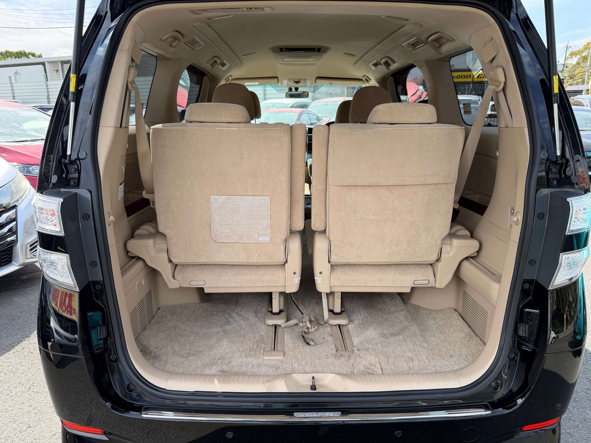 Interior view of a 2010 Toyota Vellfire 2.4L V Edition showing seating for 7 and spacious cargo area.
