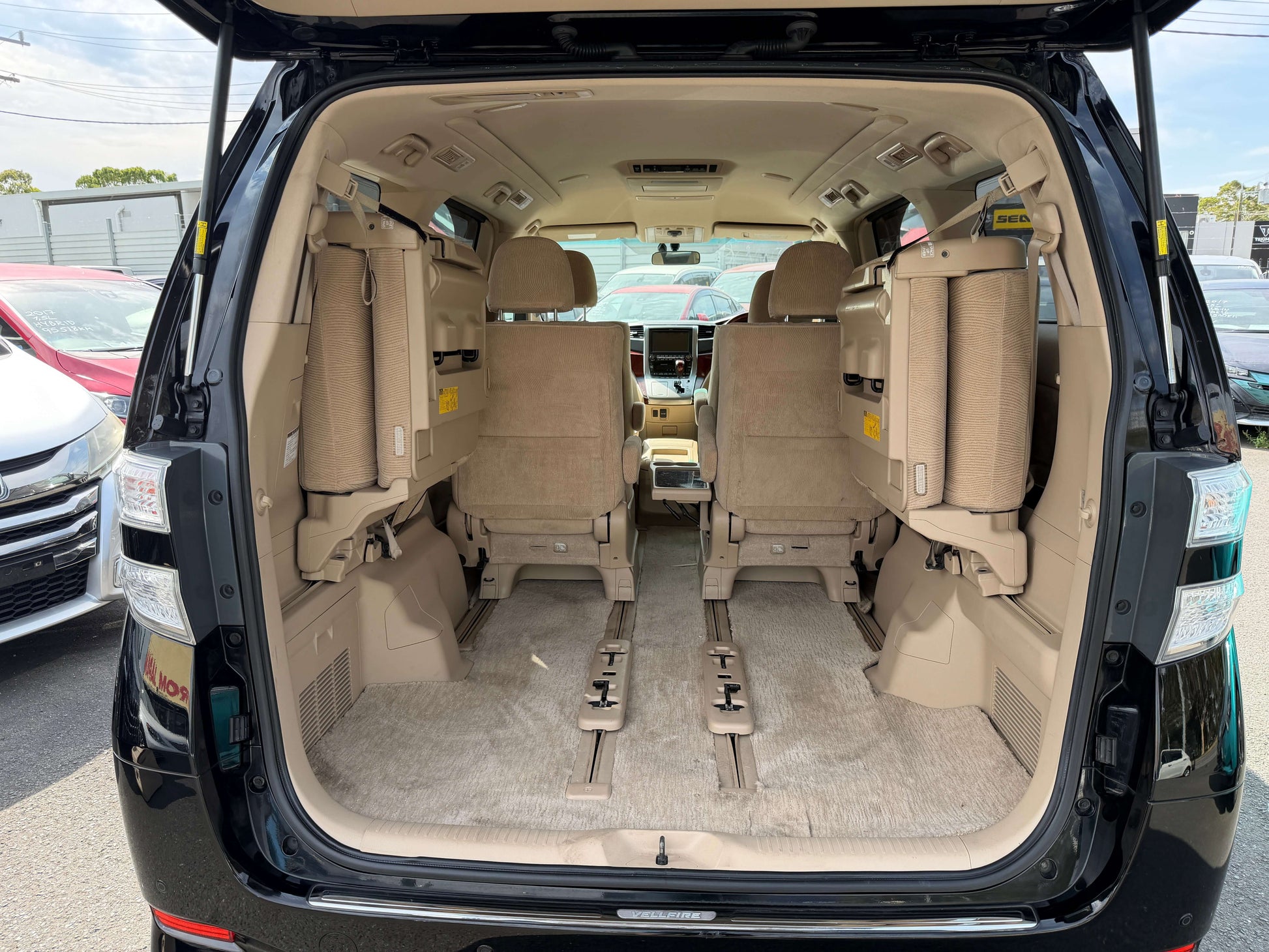 Interior view of the spacious cargo area of a 2010 Toyota Vellfire 2.4L with 7 seats, showcasing flexible seating arrangement.