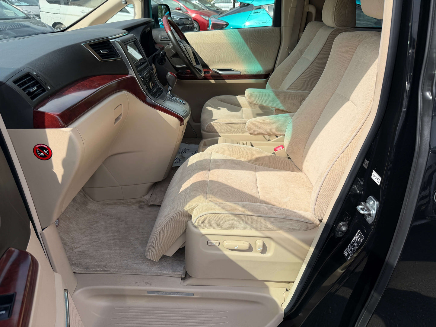 Interior view of a 2010 Toyota Vellfire 2.4L with spacious seating and beige upholstery.