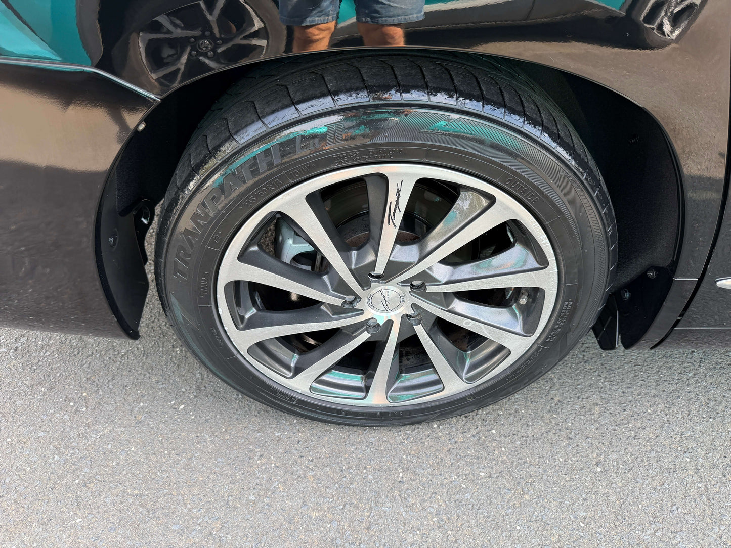 Close-up of the alloy wheel on a 2010 Toyota Vellfire 2.4L, showcasing the sleek design and tire details.