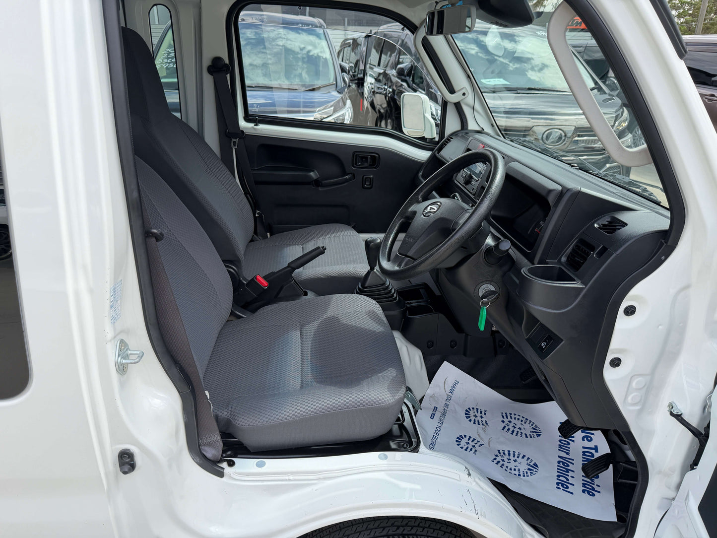 Interior view of 2021 Daihatsu Hijet Truck 660 Jumbo SA IIIt with two seats and dashboard.