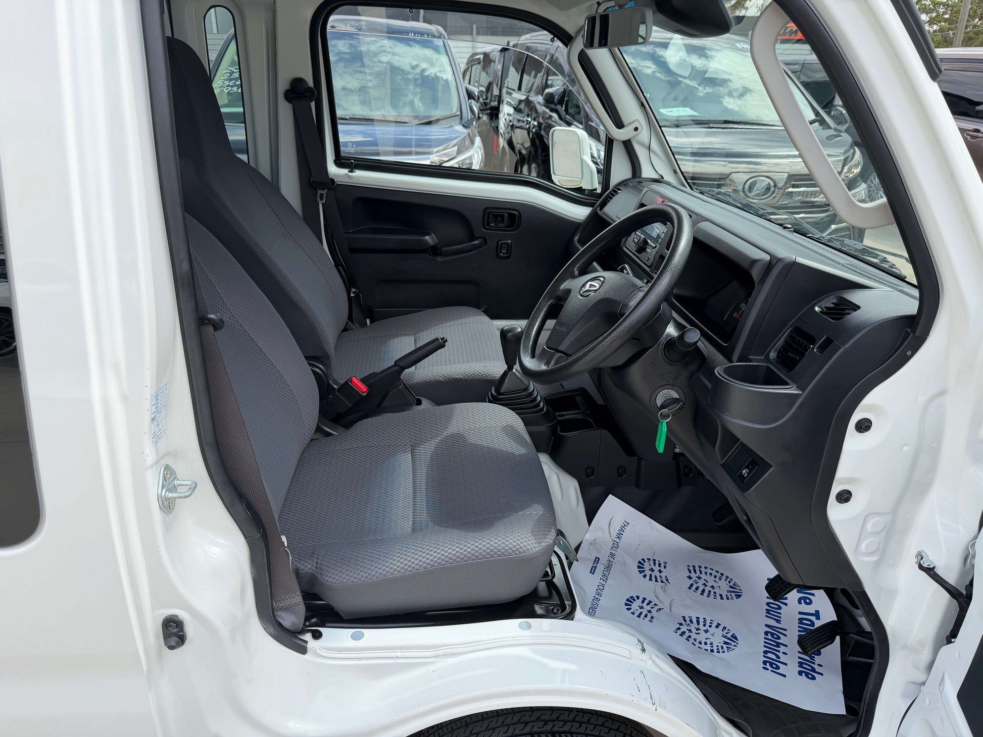Interior view of 2021 Daihatsu Hijet Truck 660 Jumbo SA IIIt with two seats and dashboard.