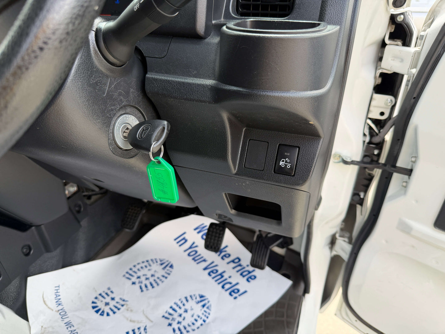 Interior view of the 2021 Daihatsu Hijet Truck 660 showing dashboard controls and key ignition.