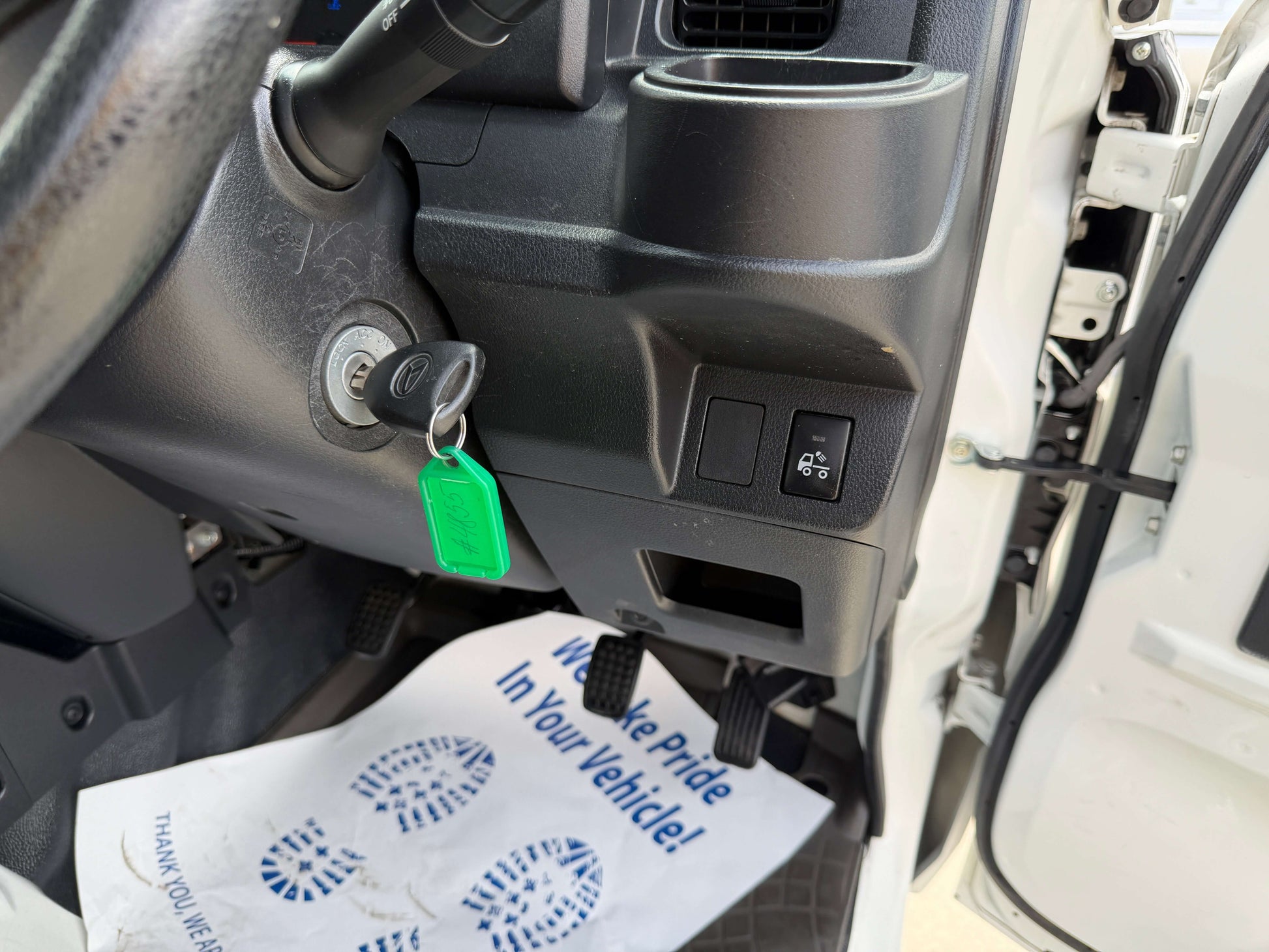 Interior view of the 2021 Daihatsu Hijet Truck 660 showing dashboard controls and key ignition.