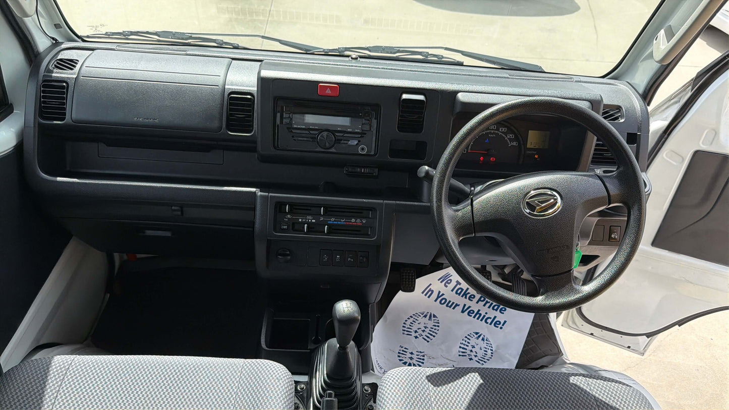 Interior view of a 2021 Daihatsu Hijet Truck 660 Jumbo SA IIIt showing dashboard and steering wheel.
