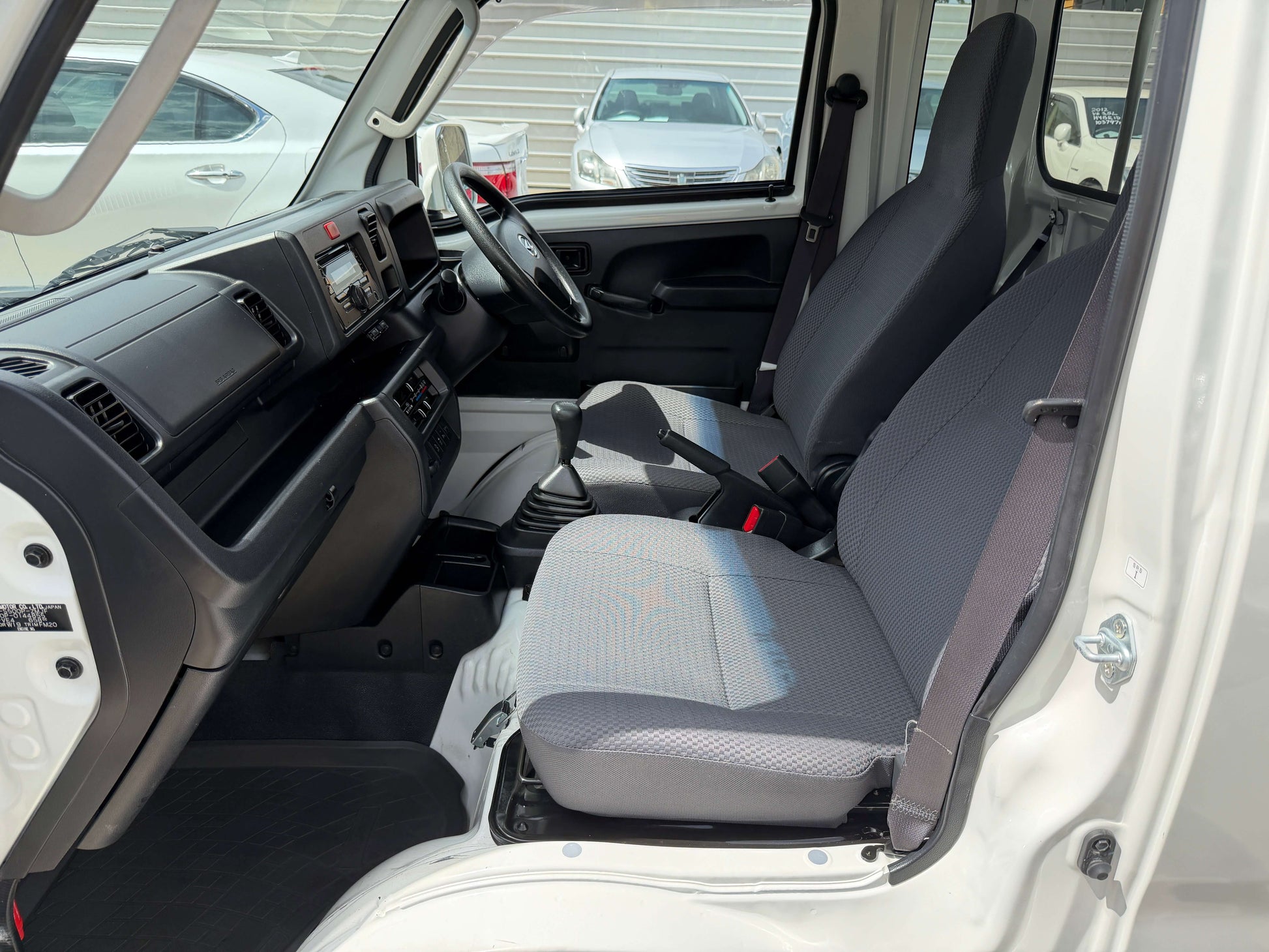 Interior view of the 2021 Daihatsu Hijet Truck 660 Jumbo SA IIIt showcasing seats and dashboard features