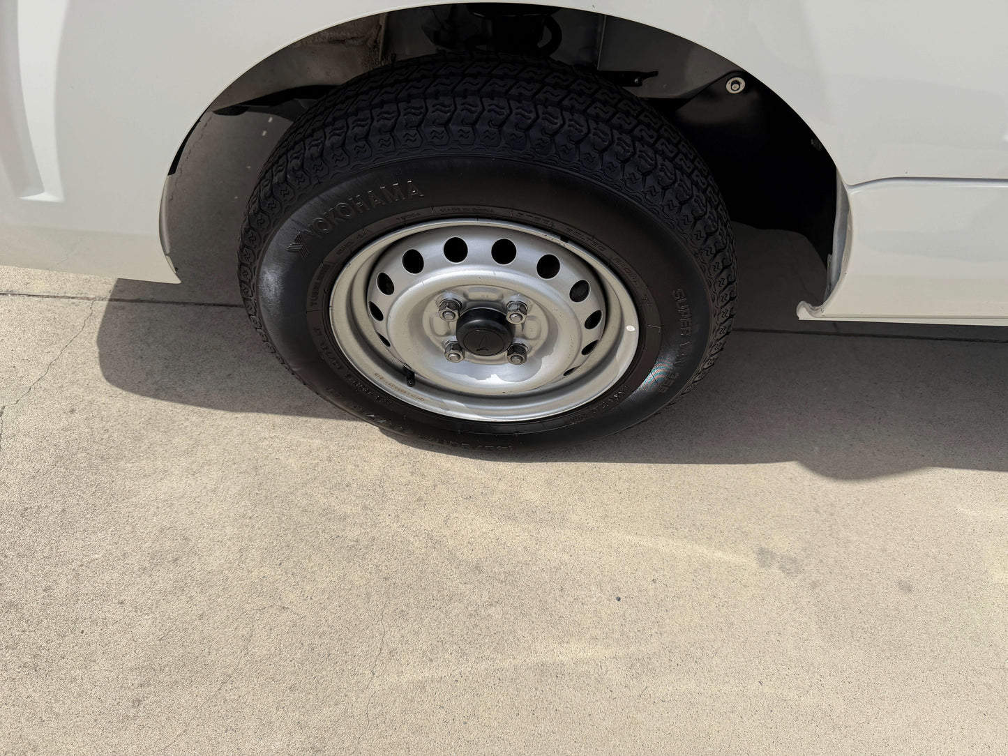 2021 Daihatsu Hijet Truck 660 wheel and tire close-up, showcasing the efficient design and functionality.