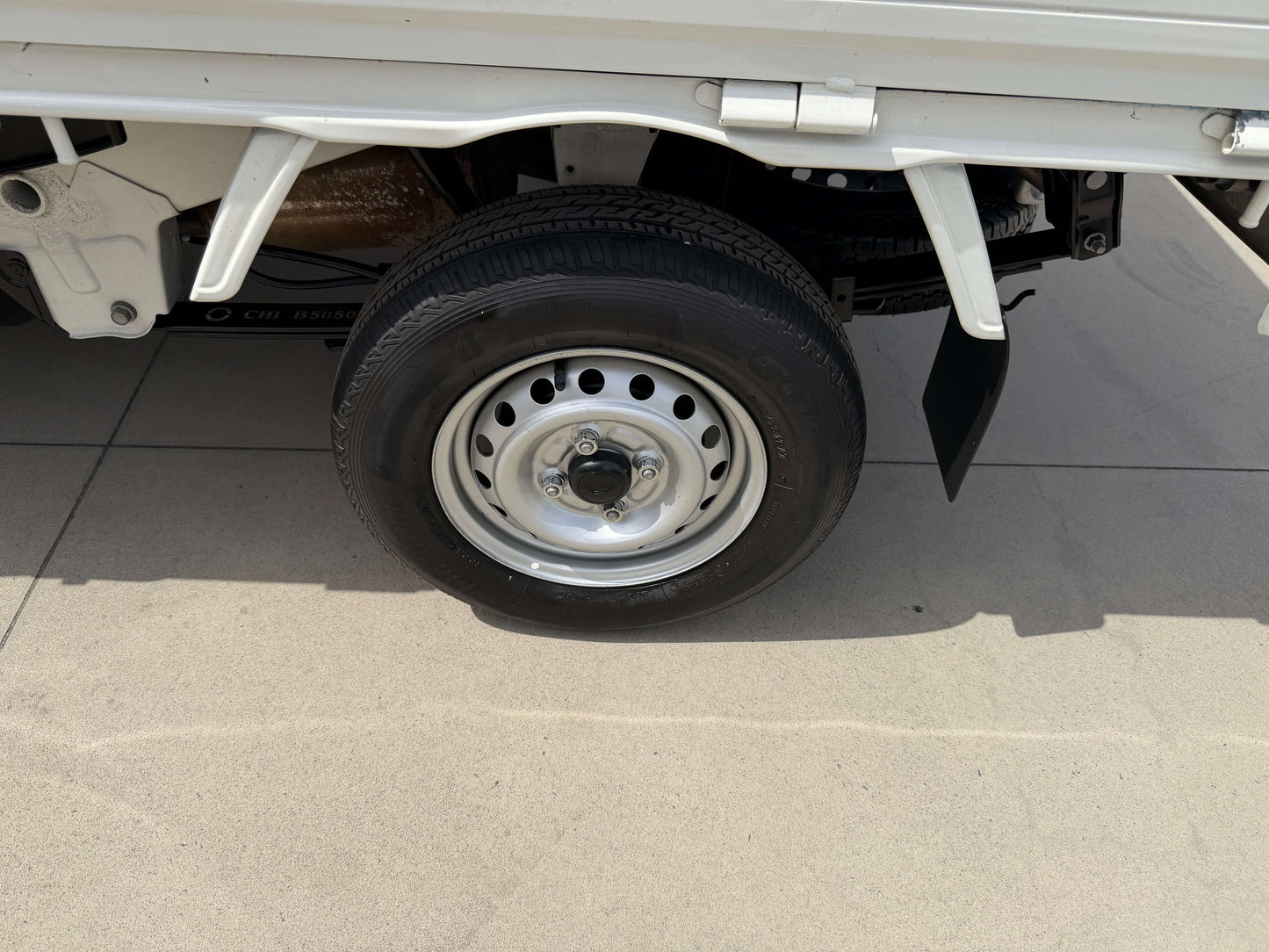 2021 Daihatsu Hijet Truck 660 detailed view of the tire and wheel on the side of the vehicle