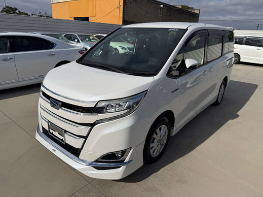 2018 Toyota Noah 1.8L Hybrid G Premium Edition 7 seater in white parked outside with clear sky.