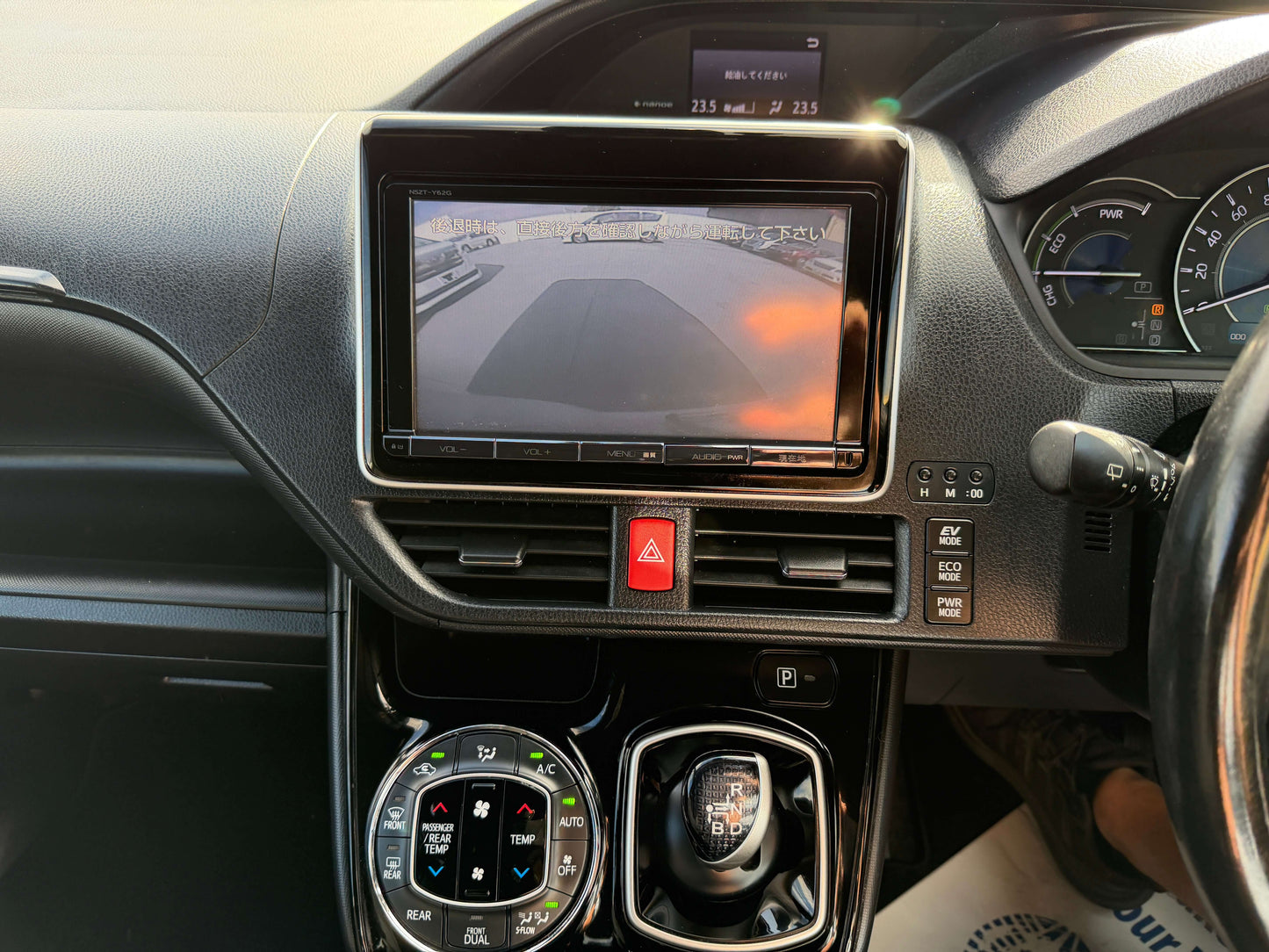 Interior view of the 2018 Toyota Noah 1.8L Hybrid G Premium Edition, featuring a central display and gear controls.