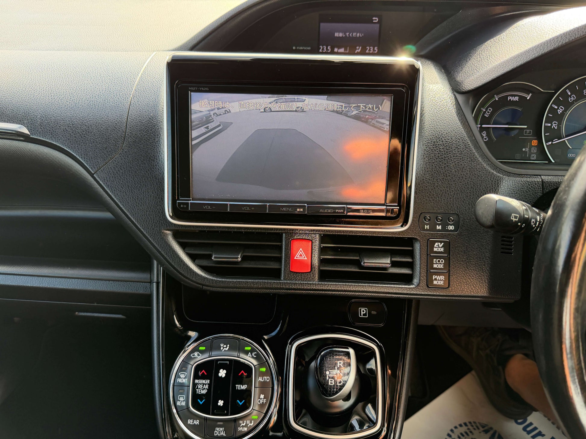 Interior view of the 2018 Toyota Noah 1.8L Hybrid G Premium Edition, featuring a central display and gear controls.