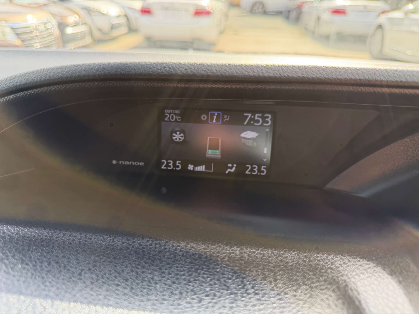 Dashboard display of the 2018 Toyota Noah 1.8L Hybrid, showing temperature and time settings.