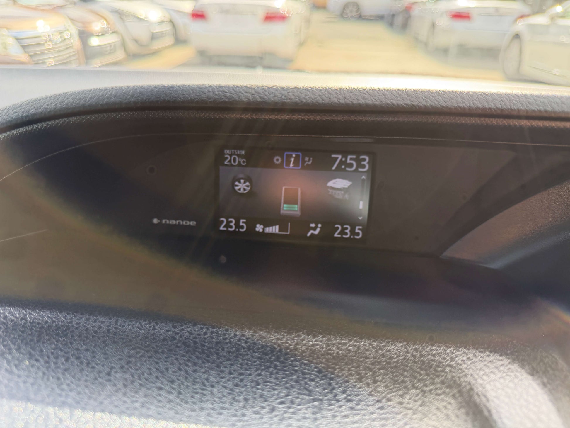 Dashboard display of the 2018 Toyota Noah 1.8L Hybrid, showing temperature and time settings.