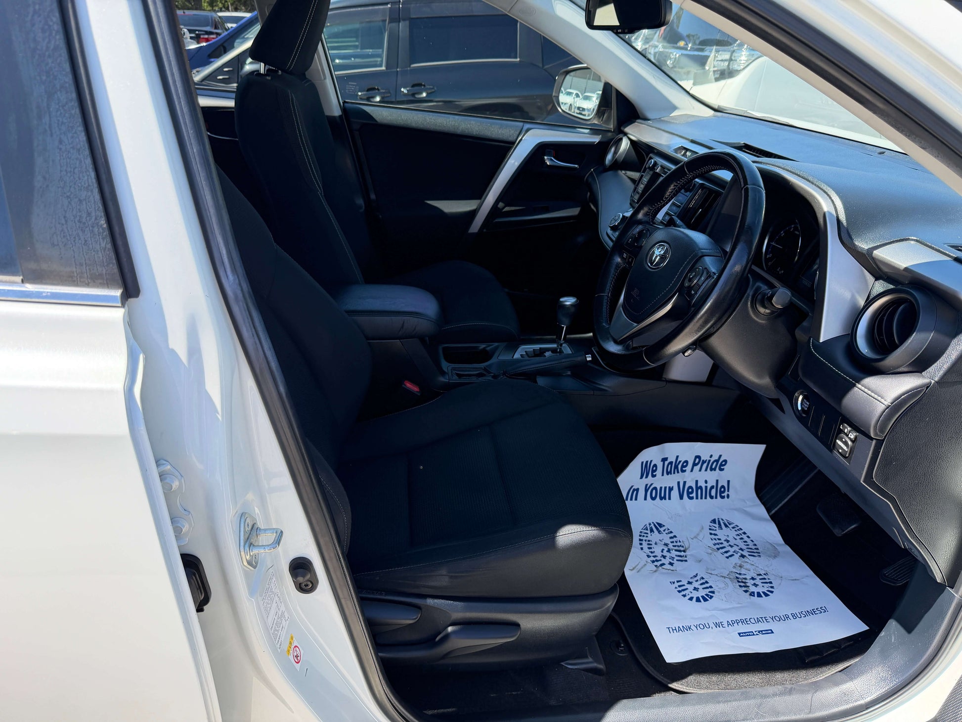 Interior view of a 2016 Toyota RAV4 showing seating and dashboard features.