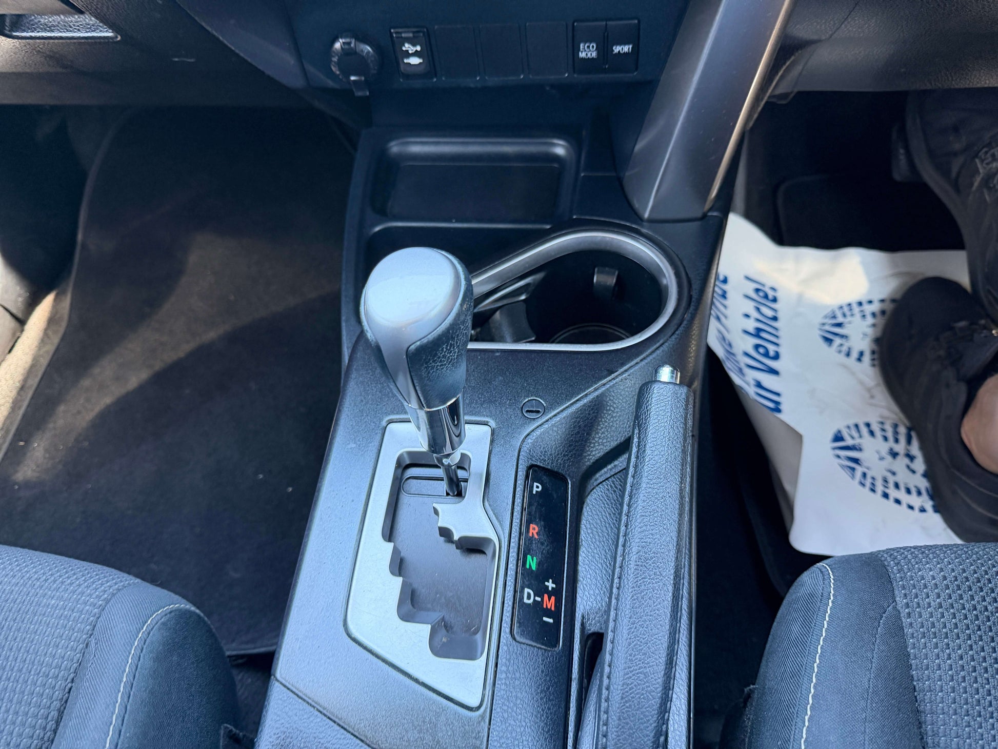 Interior view of the gear shift and console in a 2016 Toyota RAV4, showcasing automatic transmission features.