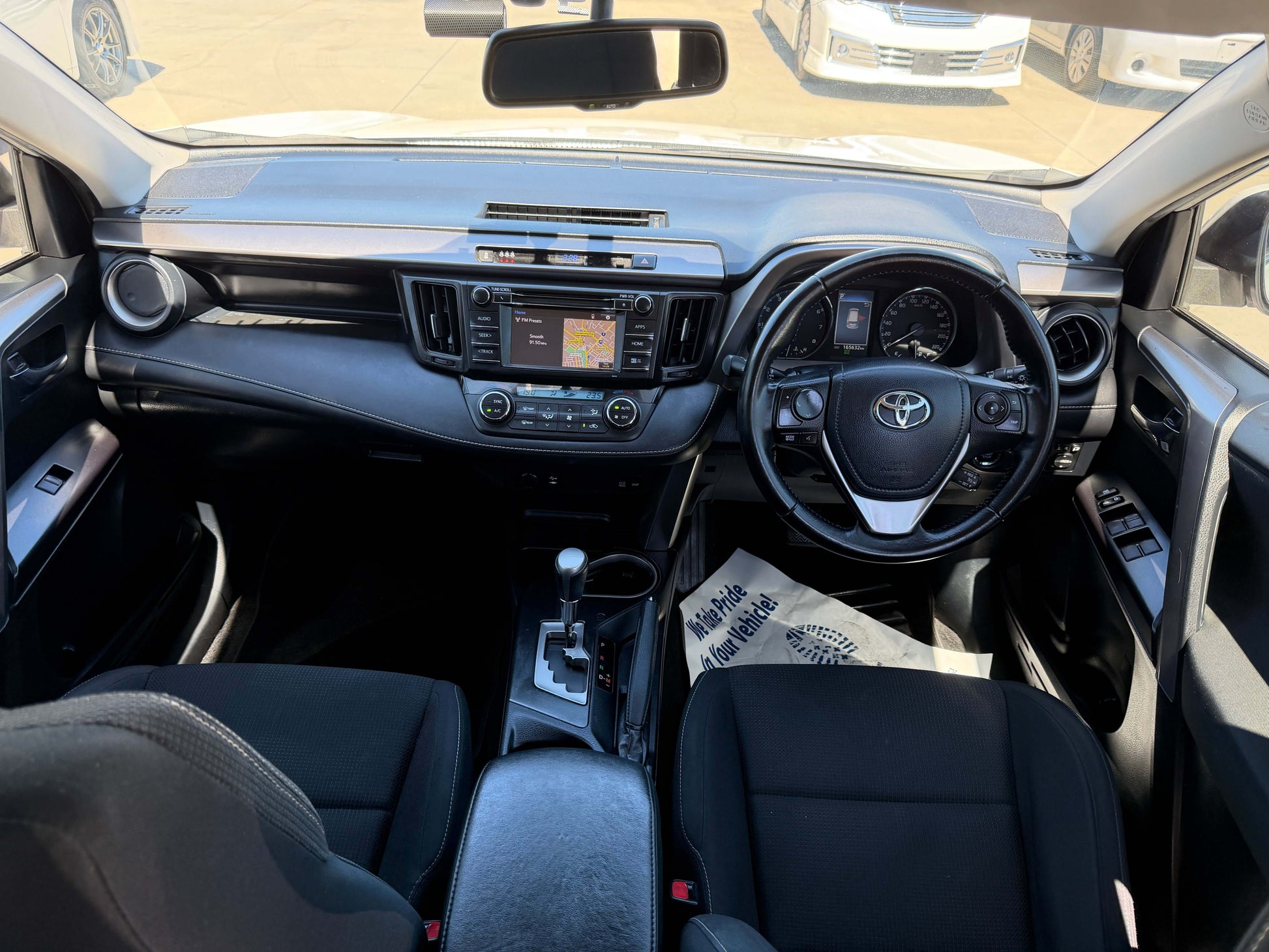 2016 Toyota RAV4 interior view showcasing dashboard, steering wheel, and seating arrangement.