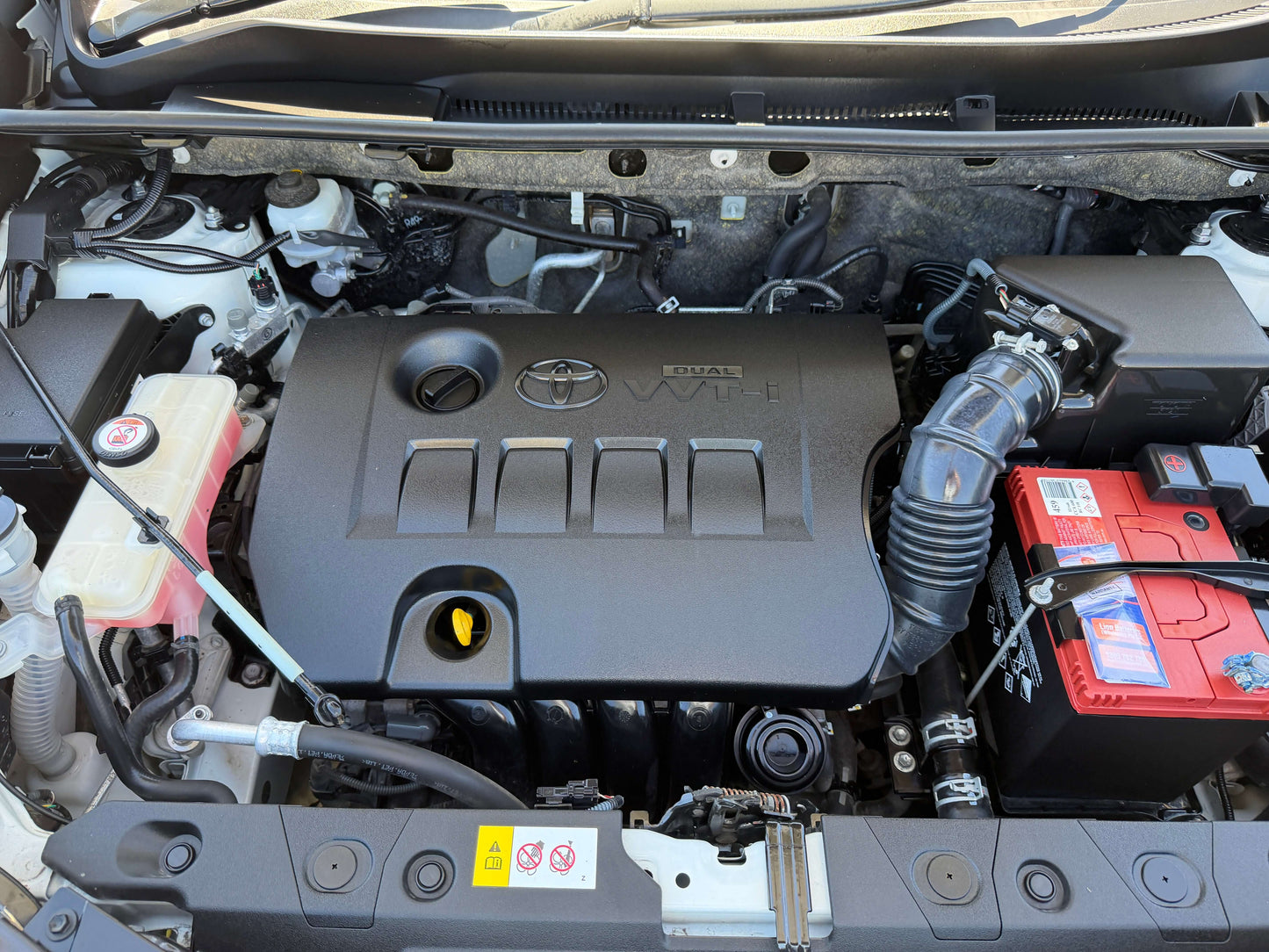 Engine compartment of a 2016 Toyota RAV4 showing the VVT-i engine with battery and components.