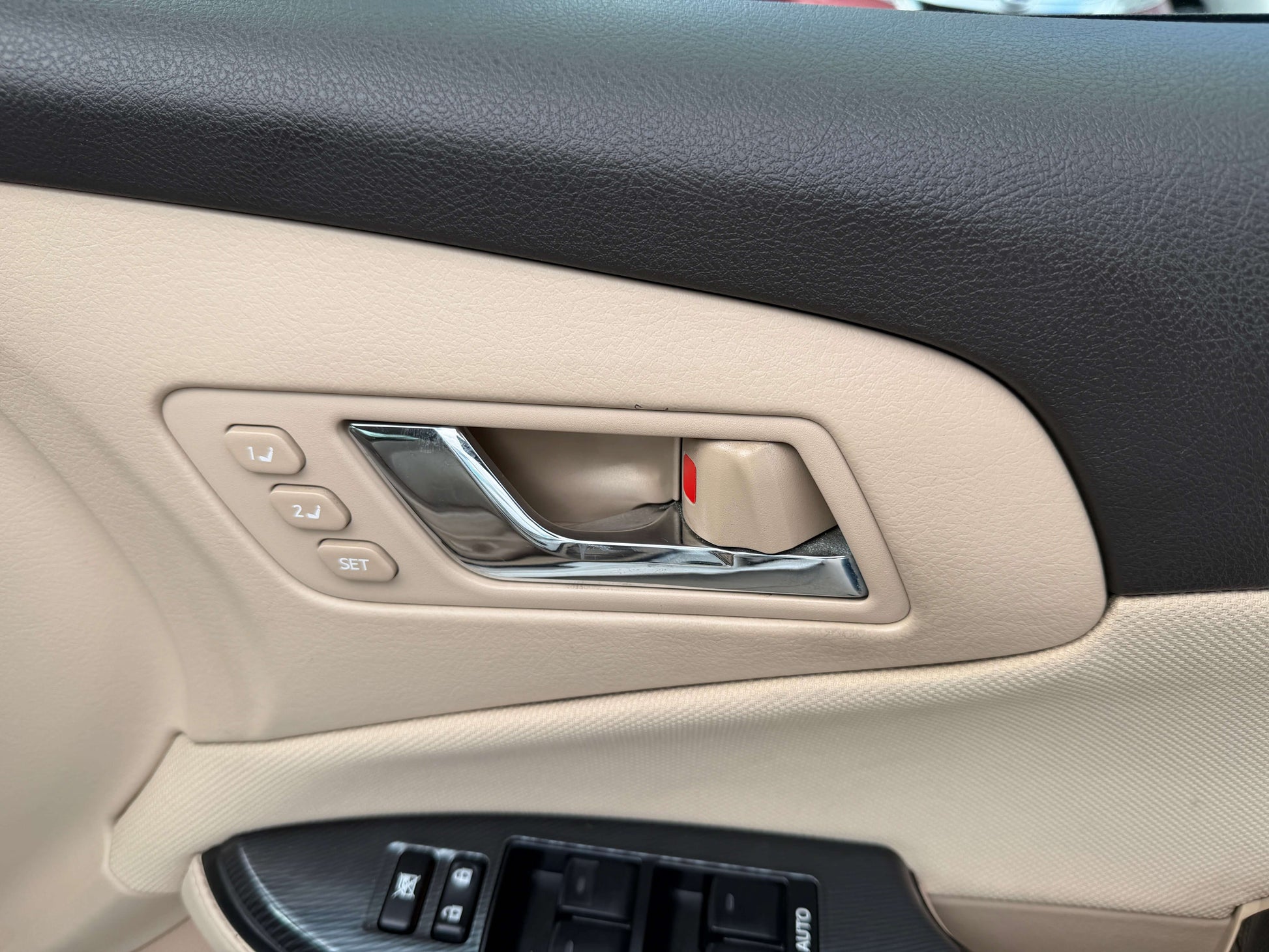 Interior door handle and control buttons of the 2009 Toyota Crown V6 3.5L Hybrid G-Edition Luxury Sedan.