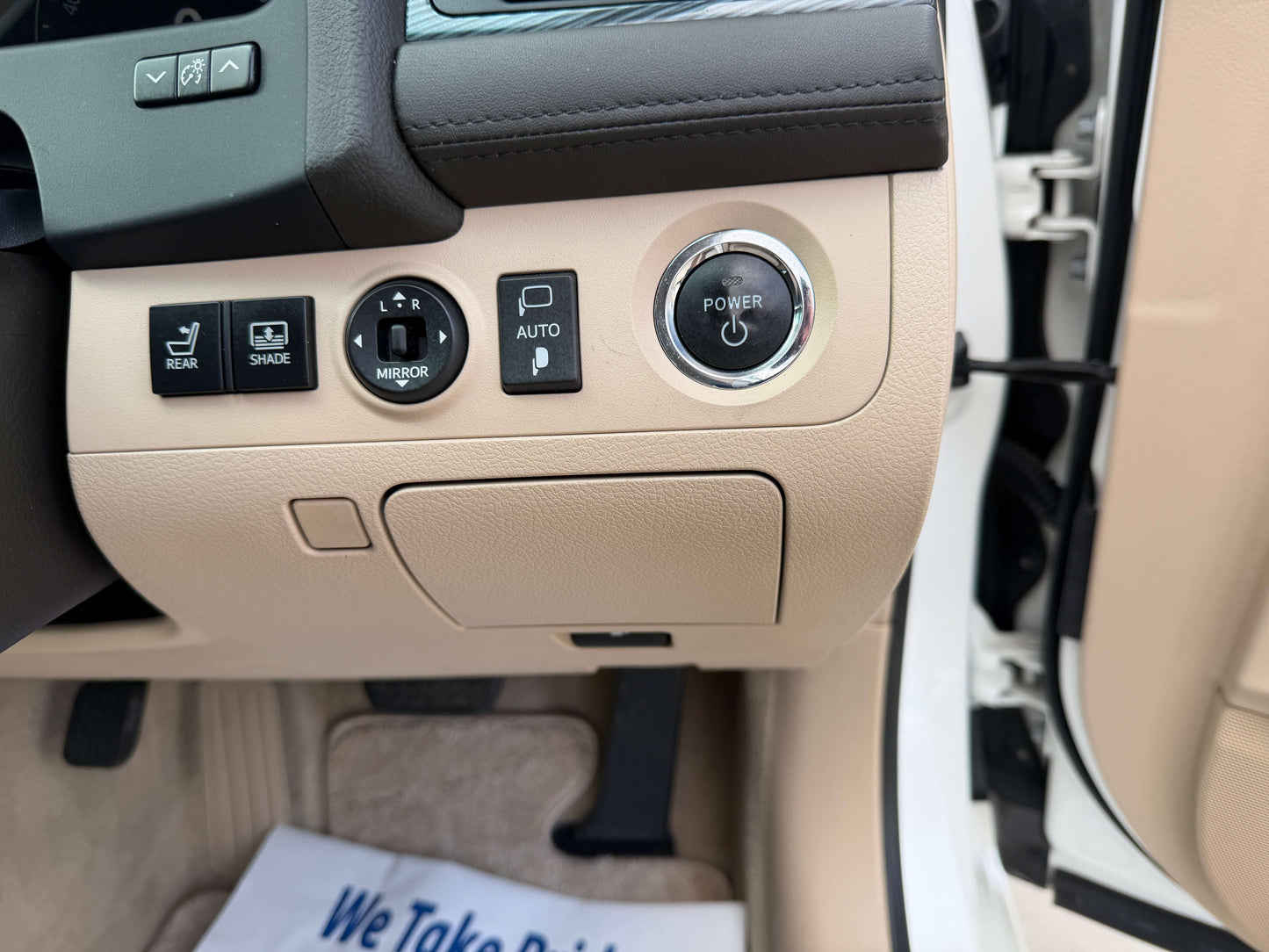 Interior controls of a 2009 Toyota Crown V6 3.5L Hybrid G-Edition Luxury Sedan, showcasing power button and adjustments.