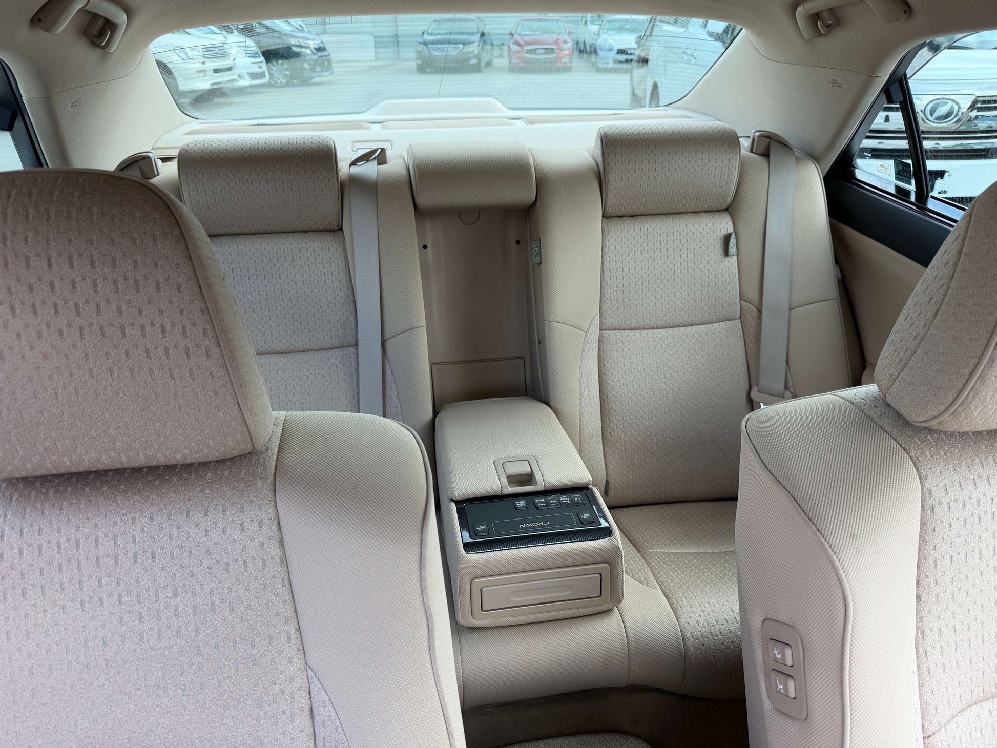 2009 Toyota Crown V6 3.5L Hybrid luxury sedan interior view showing spacious back seats and armrest.
