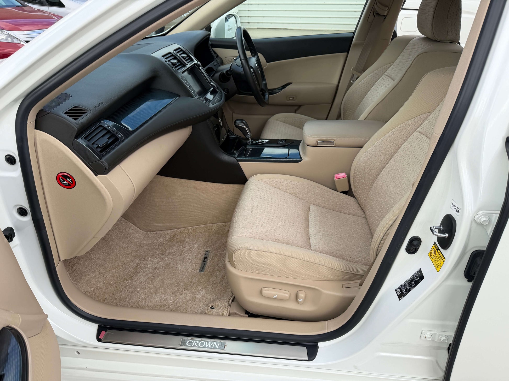Interior view of a 2009 Toyota Crown V6 3.5L Hybrid G-Edition Luxury Sedan showing beige leather seats.