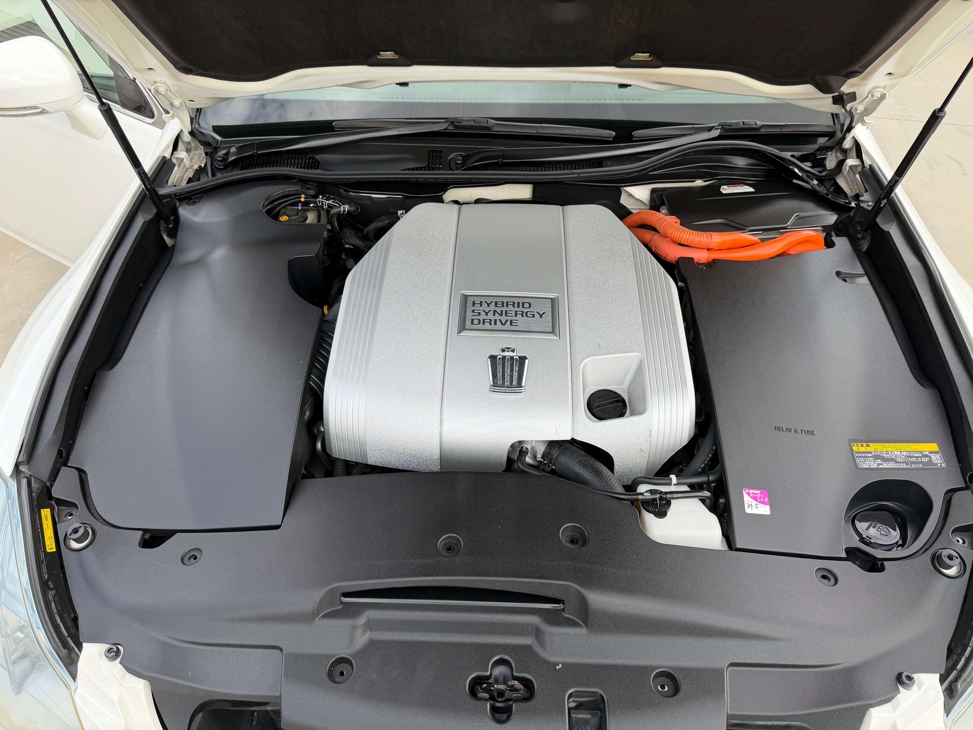 2009 Toyota Crown V6 3.5L Hybrid engine under the hood, showcasing hybrid technology and design.