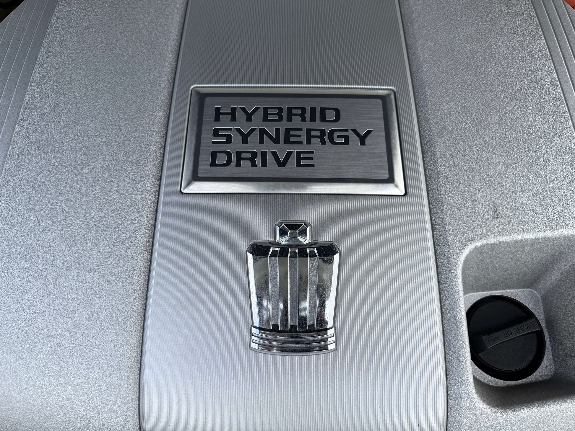 HYBRID SYNERGY DRIVE emblem on the engine cover of a 2009 Toyota Crown V6 3.5L Hybrid.