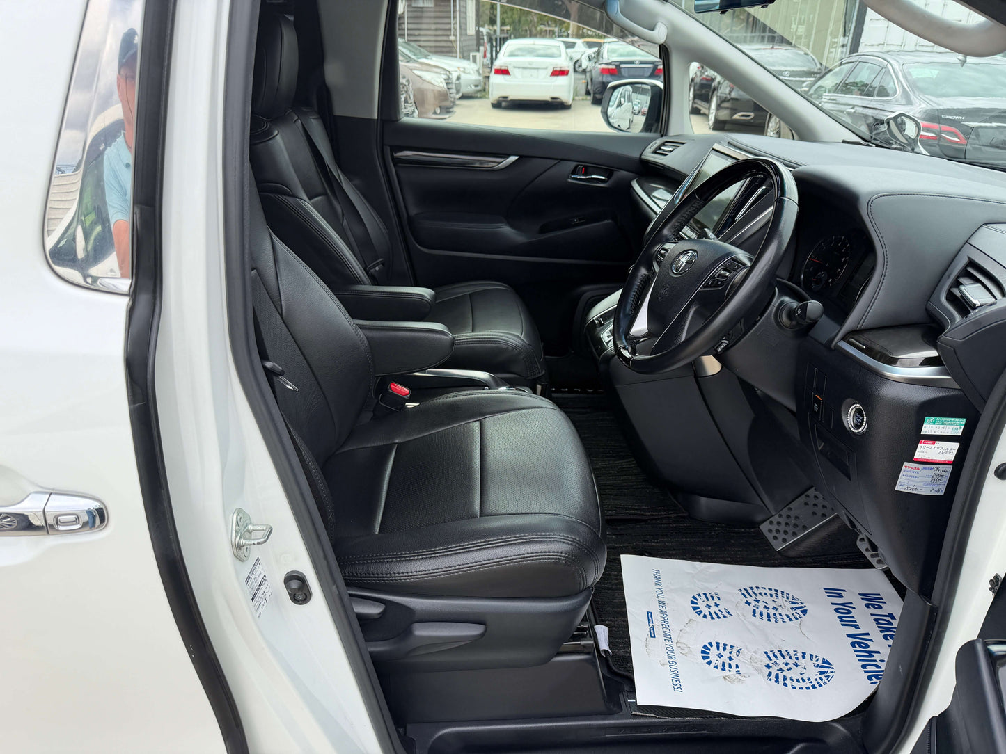 Interior view of a 2016 Toyota Alphard 2.5L SA Package showing leather seats and dashboard.